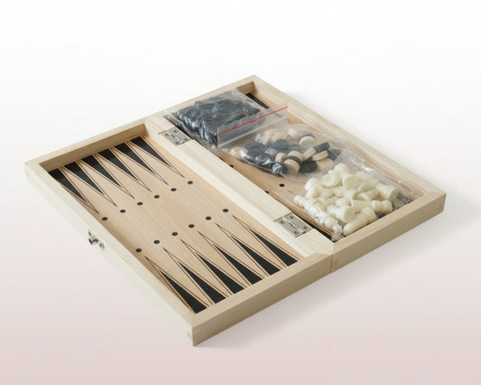 Backgammon set with pieces in a wooden box on a wooden surface