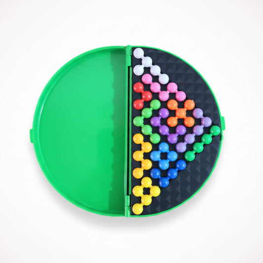 Colorful bead pattern on a circular board with green border on wooden surface