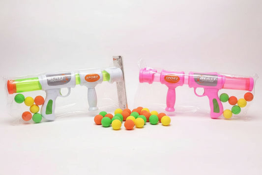 Two toy guns, one green and one pink, with colorful attachments on a wooden surface.