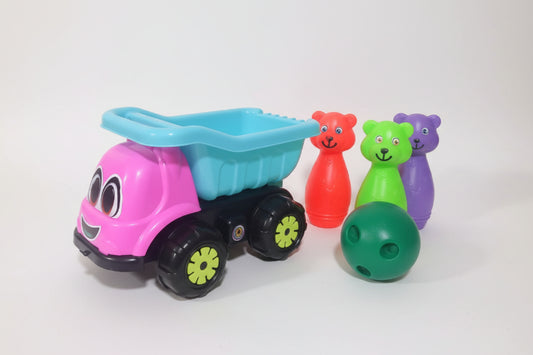 Colorful toy truck with a blue bed and pink body, towing four small bear-shaped toys on a wooden surface.