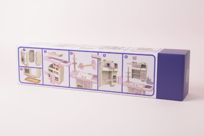 Box with step-by-step assembly instructions for a toy kitchen set on a wooden surface.