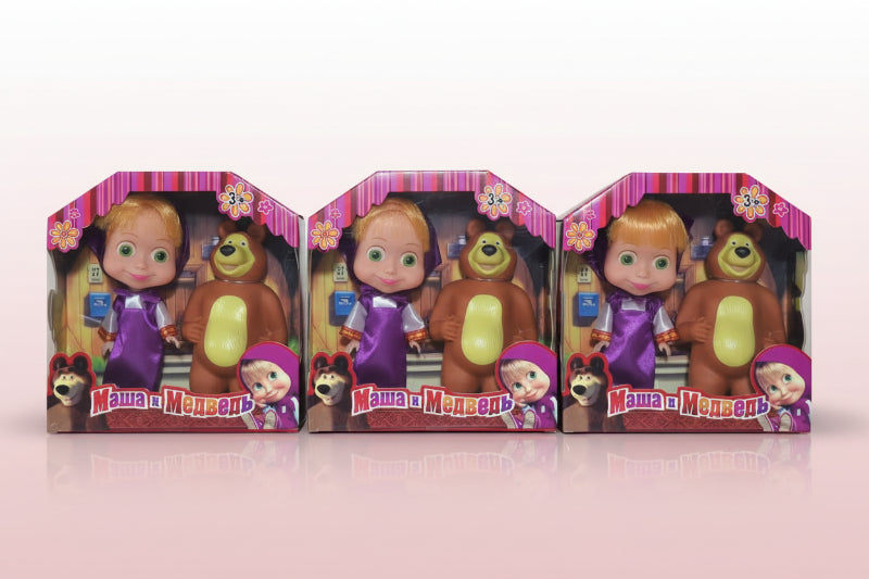 Three Masha and the Bear toy sets in packaging on a wooden surface.
