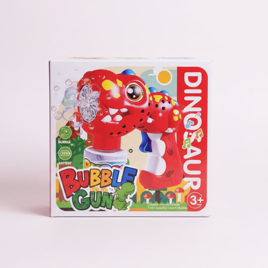 Box of a dinosaur-themed bubble gun toy on a wooden surface.