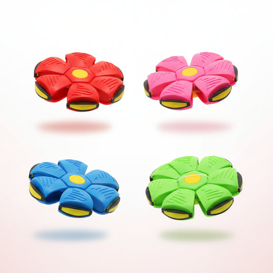 Four colorful flying discs in packaging on a wooden surface with a beige wall background.