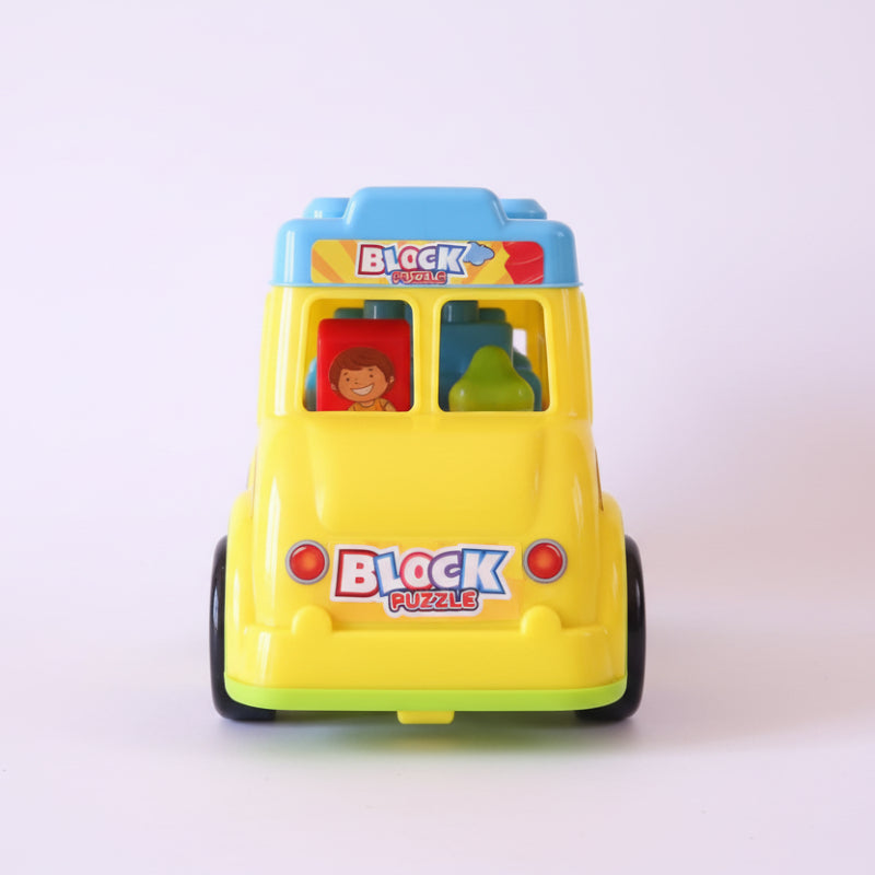 Toy block puzzle shaped like a school bus in packaging on a wooden surface.
