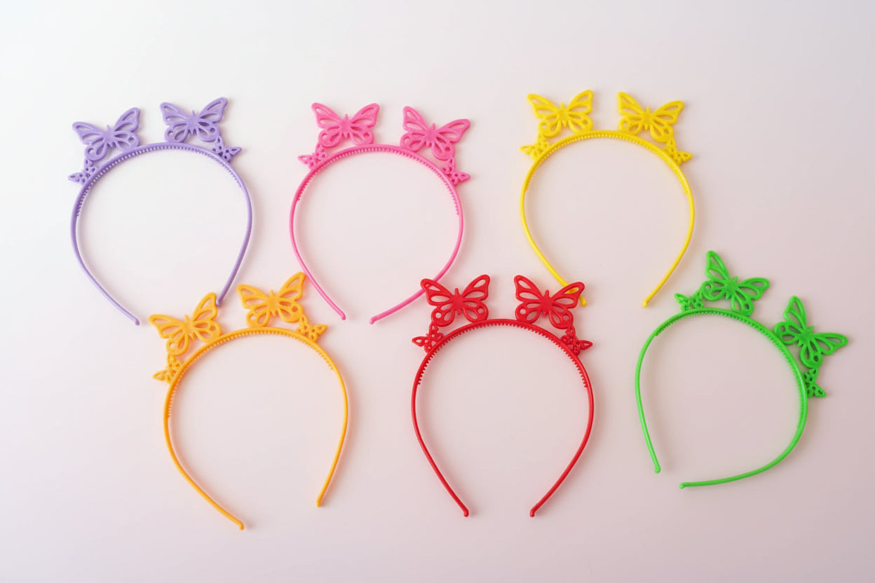 Colorful butterfly headbands on a wooden surface