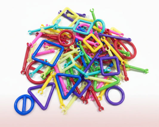 Colorful plastic geometric shapes on a wooden surface