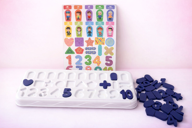 Silicone mold with letter and number impressions on a pink background