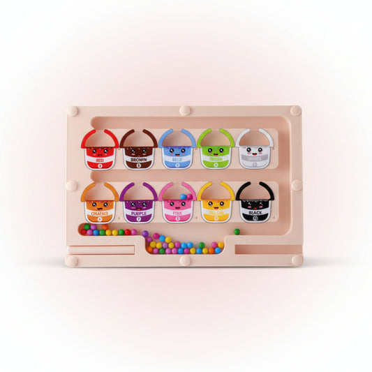 Color sorting toy with cartoon faces and color labels on a wooden surface.