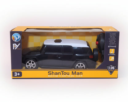Model car in packaging with 'ShanTou Man' branding on a wooden surface.