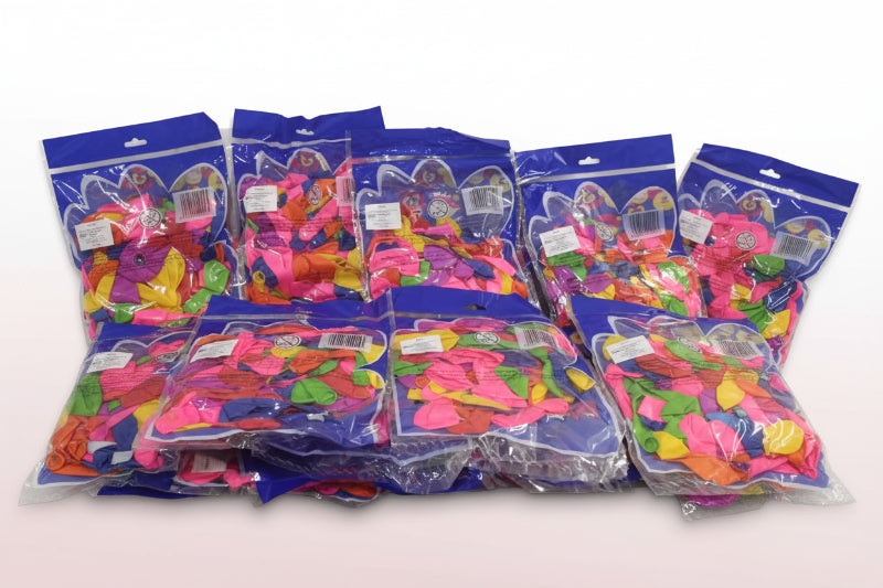 Multiple packages of colorful balloons on a wooden surface with a white background