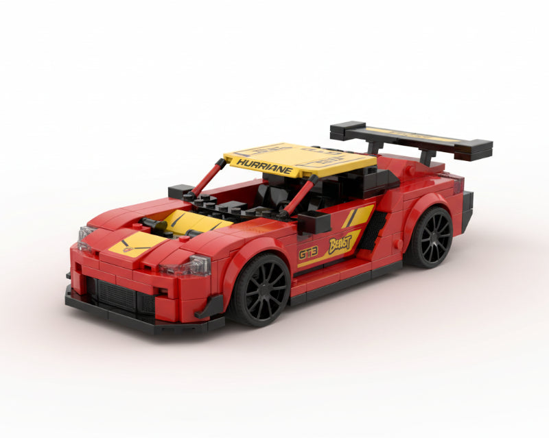 Box of a red toy car set with 'SPEED' branding on a wooden surface.