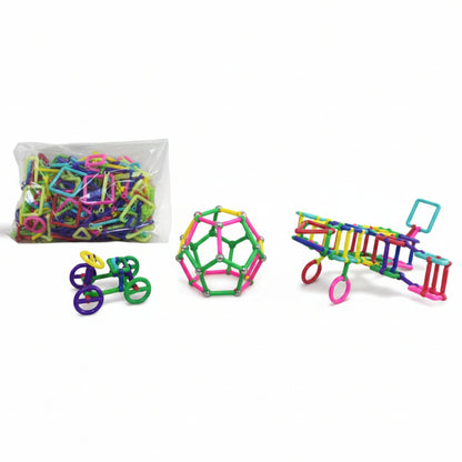 Colorful magnetic building toys on a wooden surface with a clear bag of additional toys in the background.