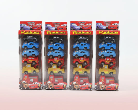 Four packages of toy cars with various designs on a wooden surface.