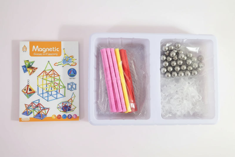 Magnetic building kit with instructions and components on a wooden surface