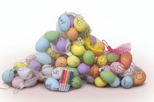 Colorful decorative items with smiley faces on a wooden surface against a white wall.