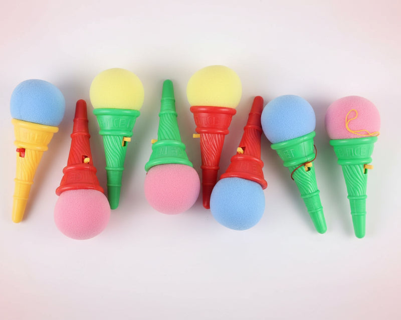 Colorful ice cream cone toys in clear packaging on a wooden surface