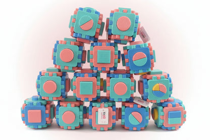 Stack of colorful baby blocks with shape patterns on a wooden surface.