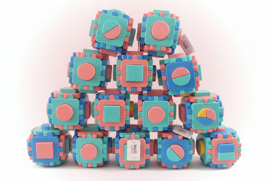 Stack of colorful baby blocks with shape patterns on a wooden surface.