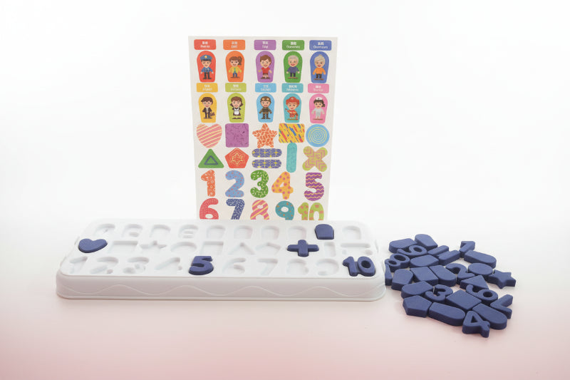 Educational tools including a set of letters, numbers, and stickers on a wooden surface.