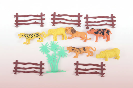 Toy animals and fences on a wooden surface