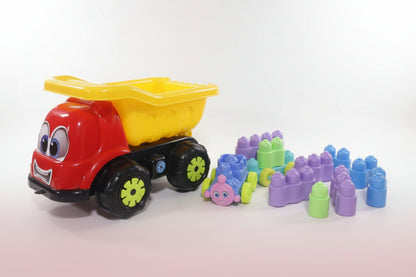 Colorful toy dump truck with building blocks on a wooden surface