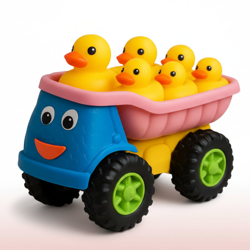 Toy truck with a blue body and pink bed carrying yellow rubber ducks on a colorful play mat.