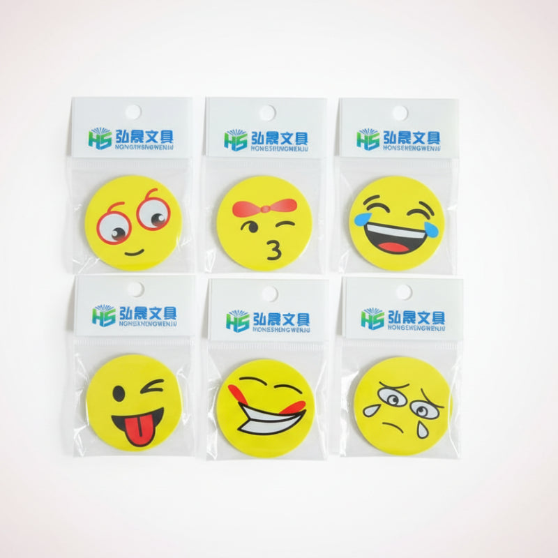 Set of six yellow smiley face stickers on clear cards with brand name on a wooden surface