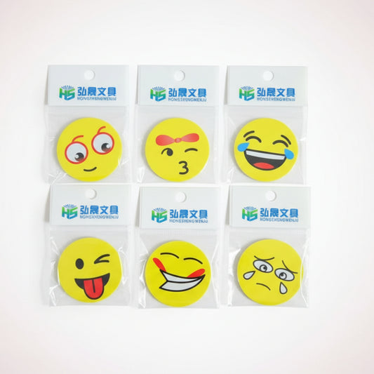 Set of six yellow smiley face stickers on clear cards with brand name on a wooden surface