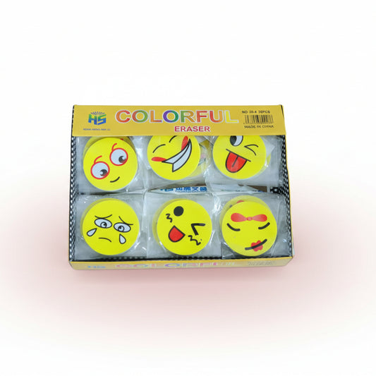 Box of colorful erasers with emoji designs on a wooden surface