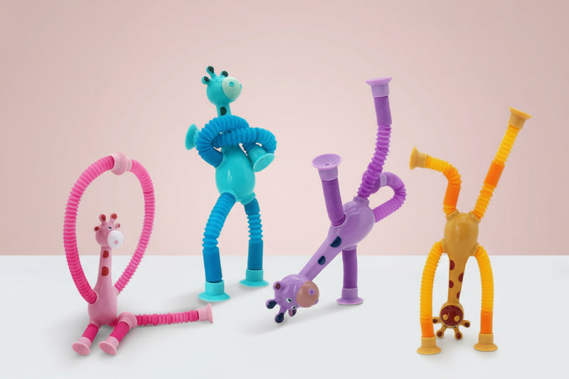 Two children playing with colorful bendy toy figures on a light surface.