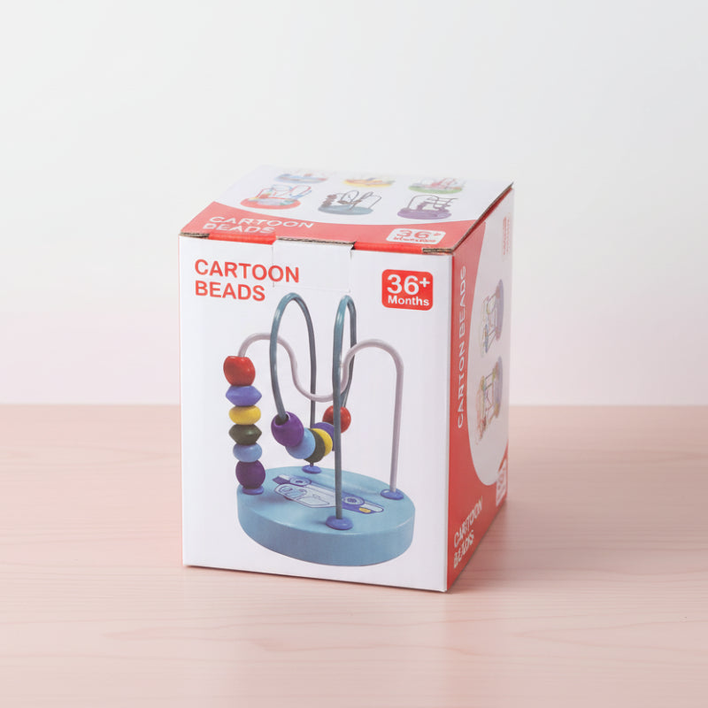 Cartoon beads toy packaging on a wooden surface with a white background
