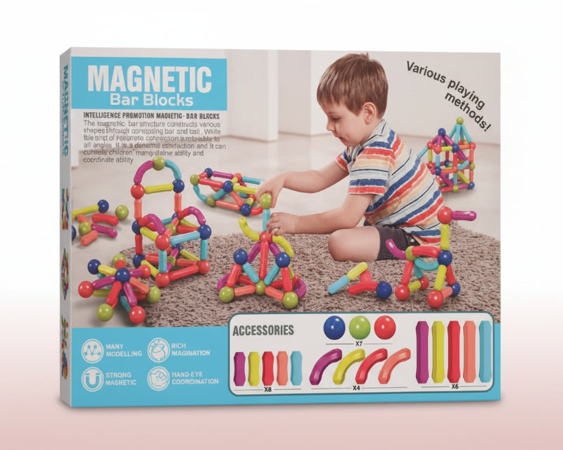 Box of magnetic bar blocks with a child playing with the toys on a wooden surface.