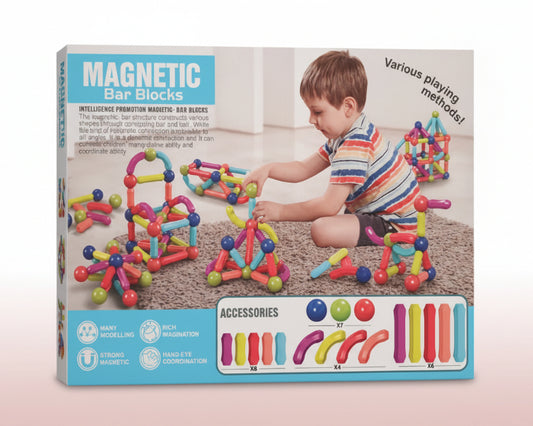 Box of magnetic bar blocks with a child playing with the toys on a wooden surface.