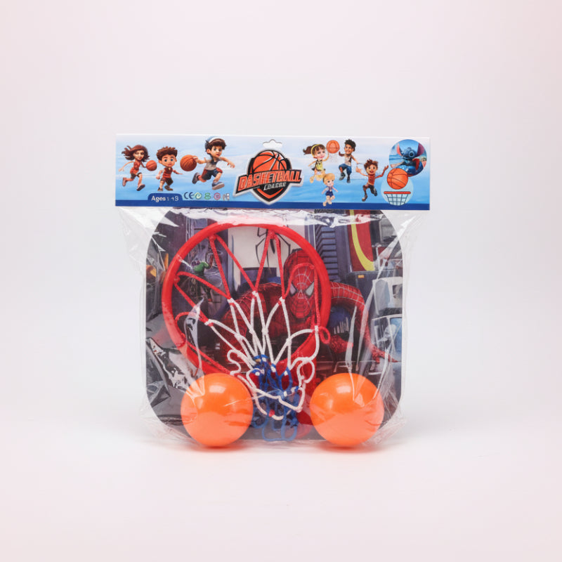 Toy basketball hoop set with two orange balls in clear packaging against a white wall.
