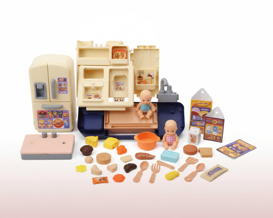 Collection of toy food items and kitchen accessories on a wooden surface