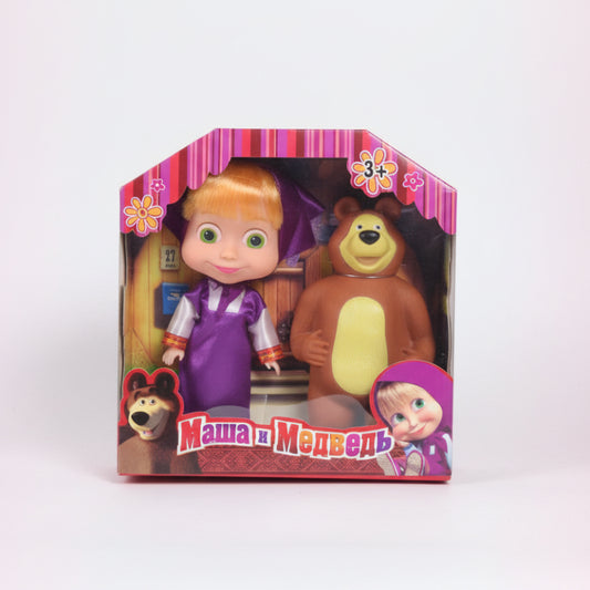 Toy packaging featuring a girl and a bear on a wooden surface with a white background