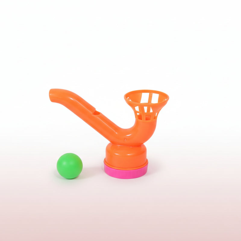 Orange plastic toy with a green ball on a wooden surface