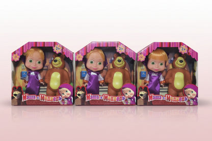 Three Masha and the Bear toy sets in packaging on a wooden surface.