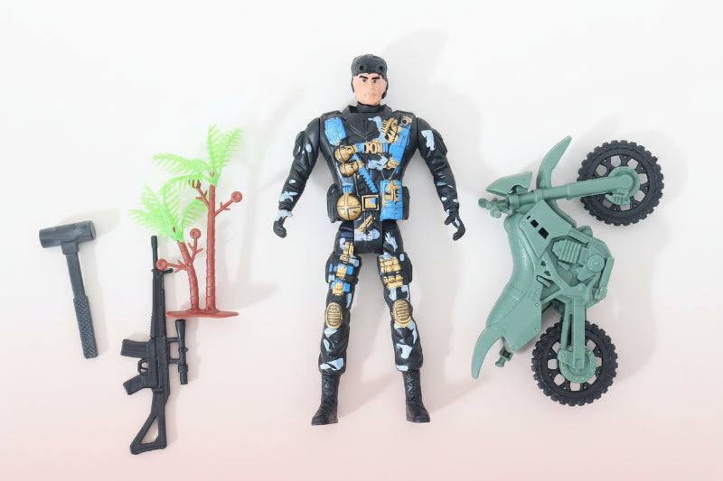 Toy figure of a soldier with a motorcycle and small plants on a wooden surface