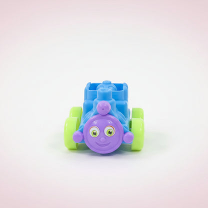 Toy train made of interlocking blocks on a wooden surface with a white background