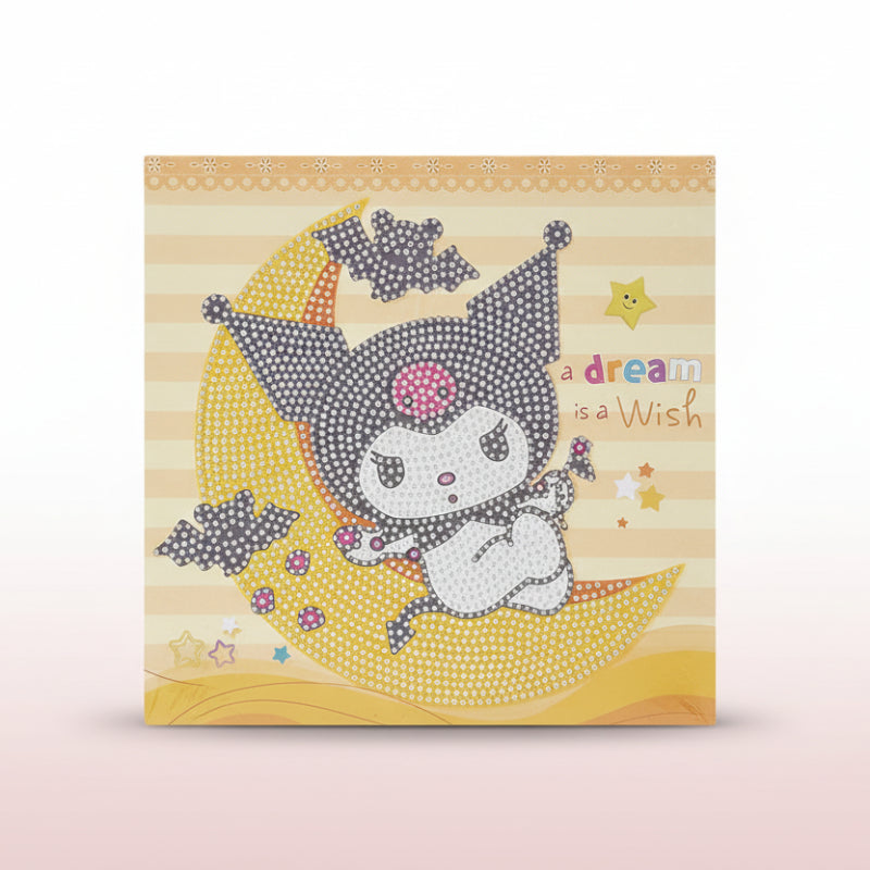 Card with a cartoon character on a moon, text 'A dream is a wish', on a wooden surface.