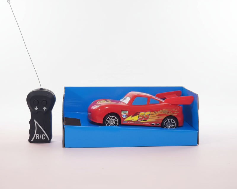 Toy car in packaging with remote control on a wooden surface
