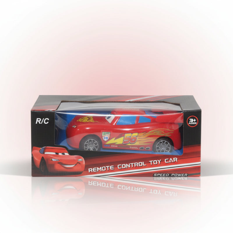 Red remote control toy car in packaging on a wooden surface