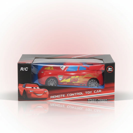 Red remote control toy car in packaging on a wooden surface