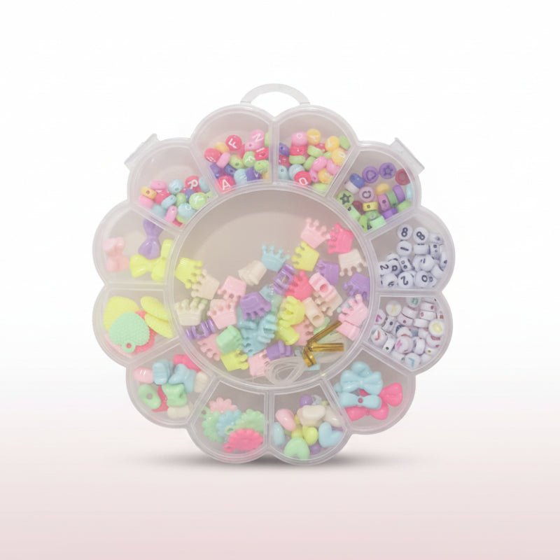 Clear plastic container with compartments filled with colorful decorative items on a white surface.