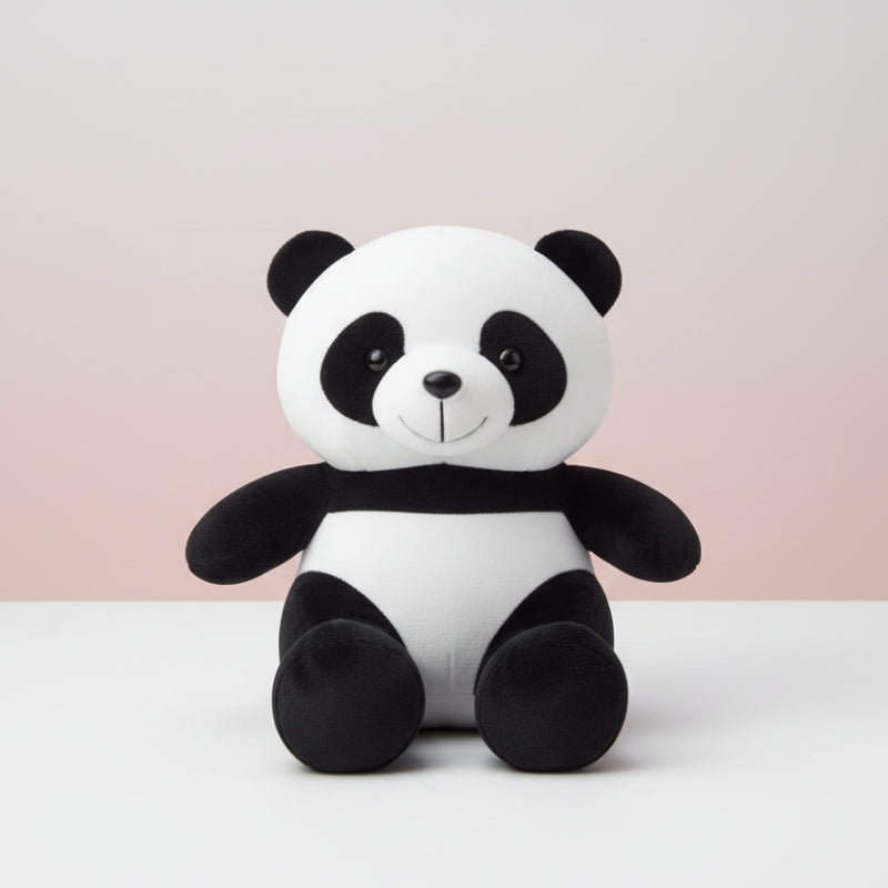 Plush panda toy on a wooden surface with a white background