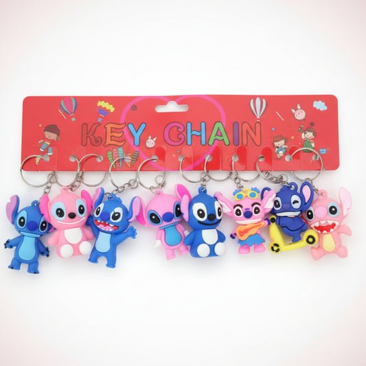 Set of colorful keychains on a wooden surface with a red keychain holder in the background.