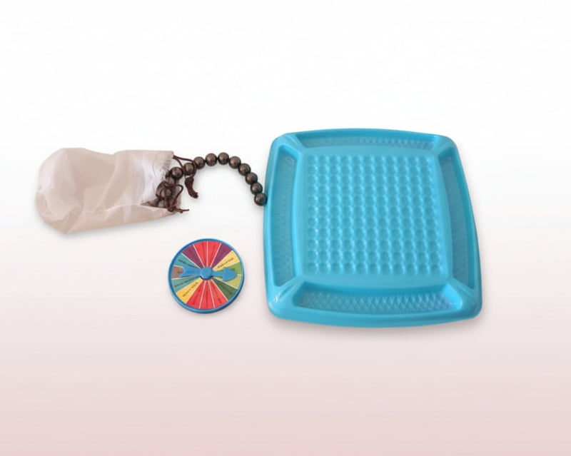 Blue textured tray, colorful wheel, coffee beans, and paper on a wooden surface