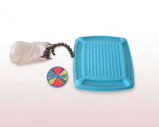 Blue textured tray, colorful wheel, coffee beans, and paper on a wooden surface